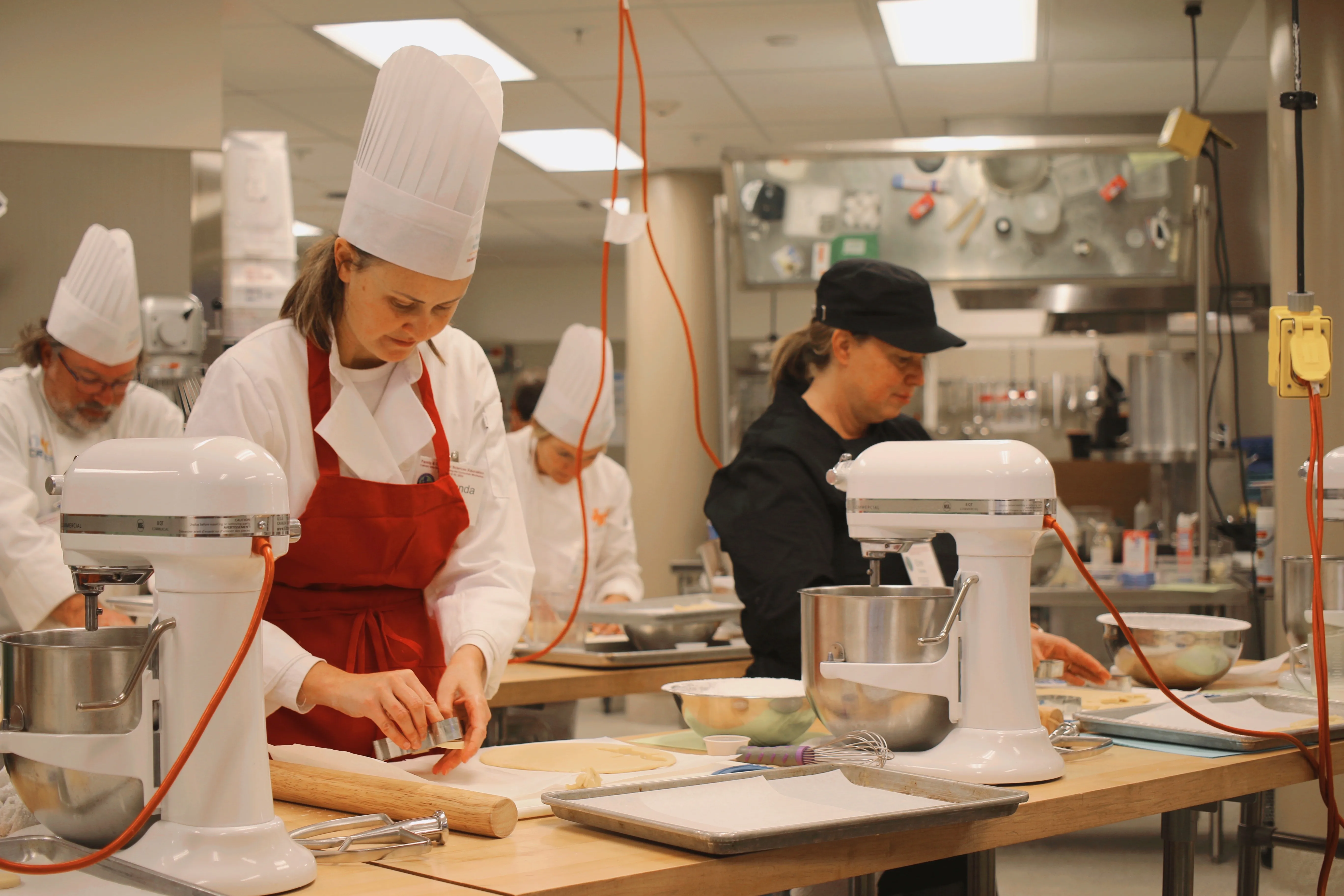 chefs in a kitchen with mixers